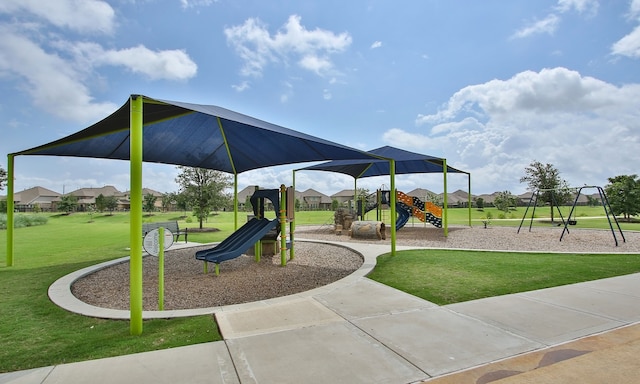 view of playground with a lawn