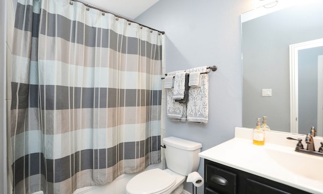 bathroom with vanity, curtained shower, and toilet