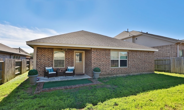 rear view of house featuring a lawn and a patio area