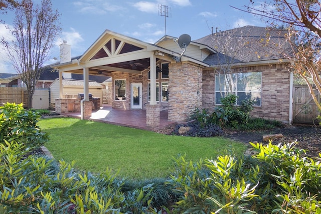 rear view of property featuring area for grilling, ceiling fan, a yard, and a patio area