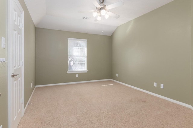 carpeted spare room with ceiling fan and vaulted ceiling