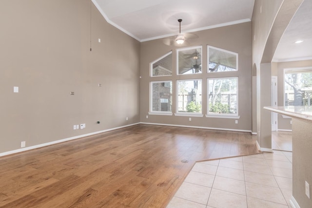 unfurnished dining area featuring ceiling fan, light hardwood / wood-style floors, and crown molding