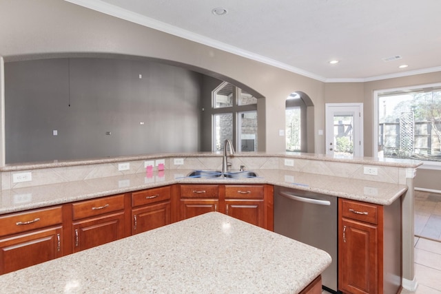 kitchen with light stone countertops, sink, a center island, stainless steel dishwasher, and crown molding