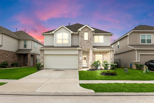 view of front of house with a garage and a yard