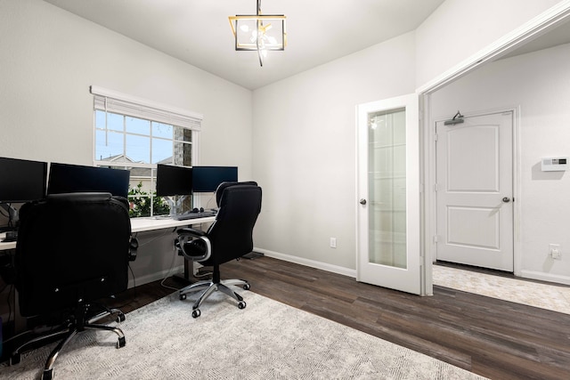 home office featuring dark hardwood / wood-style flooring and a chandelier