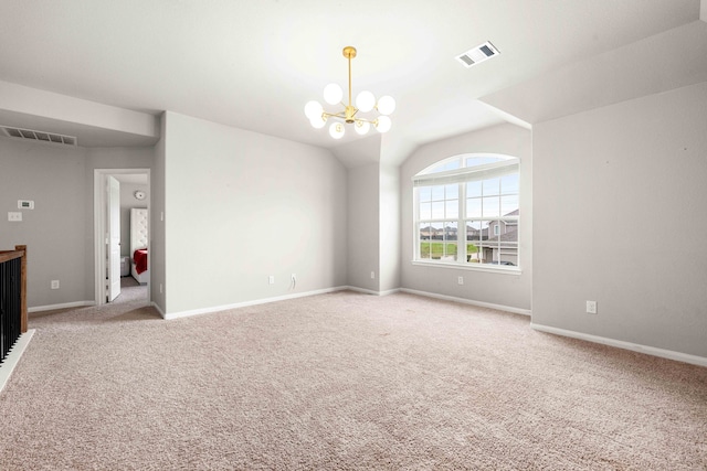 unfurnished room featuring carpet floors, an inviting chandelier, and vaulted ceiling