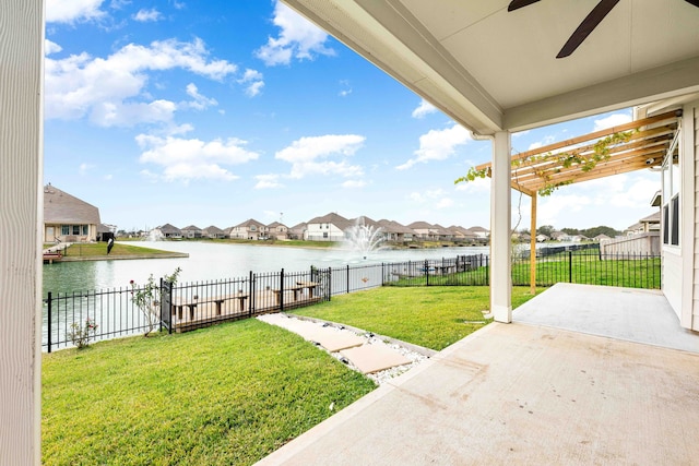 view of yard featuring a patio, a water view, and ceiling fan