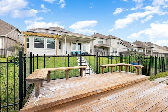 wooden terrace featuring a yard and ceiling fan