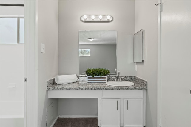 bathroom with a shower and vanity