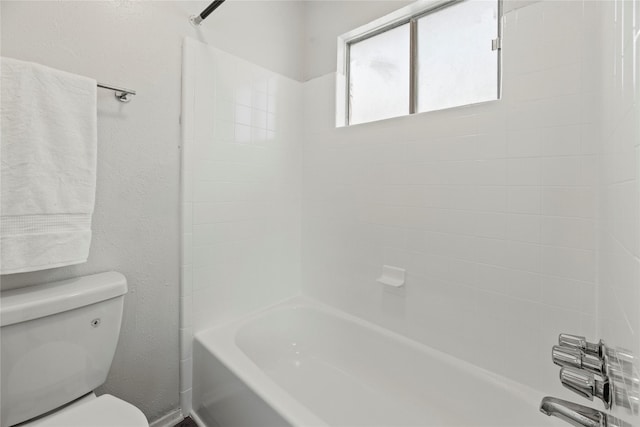 bathroom featuring shower / bathing tub combination and toilet