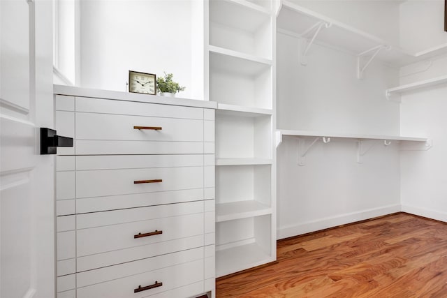 spacious closet with light hardwood / wood-style floors