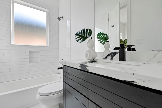 full bathroom featuring tiled shower / bath, vanity, and toilet