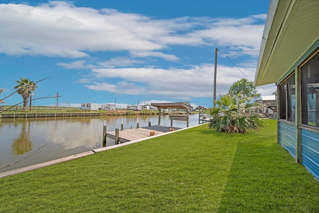 dock area with a yard and a water view