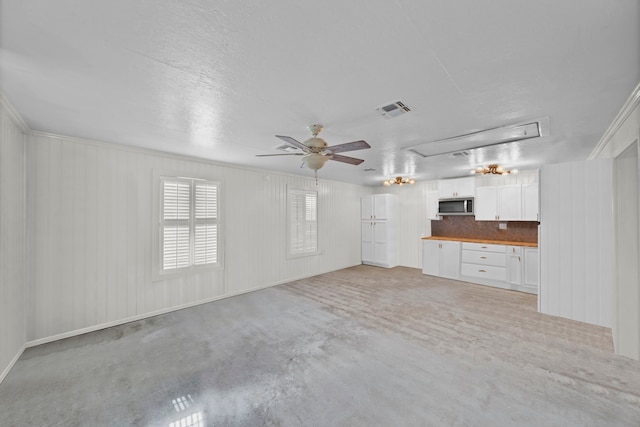 unfurnished living room with ceiling fan