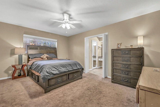 carpeted bedroom with ceiling fan and connected bathroom