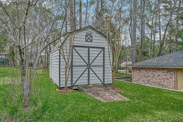 view of outdoor structure featuring a lawn