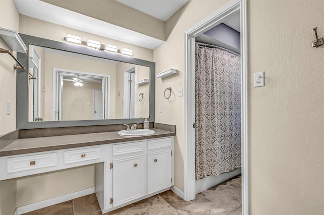 bathroom featuring a shower with shower curtain, ceiling fan, and vanity