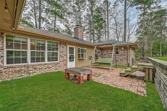 exterior space featuring a lawn and a patio area