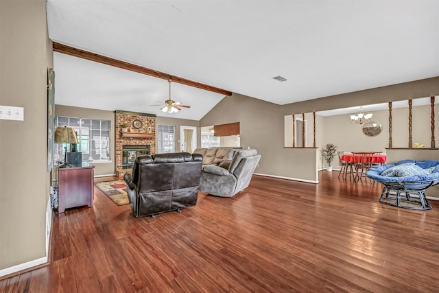 living room with a fireplace, ceiling fan with notable chandelier, lofted ceiling with beams, and dark hardwood / wood-style floors