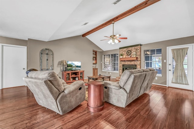 living room featuring lofted ceiling with beams, ceiling fan, dark wood-type flooring, and a brick fireplace