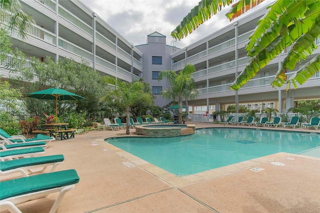 view of pool with a community hot tub and a patio area