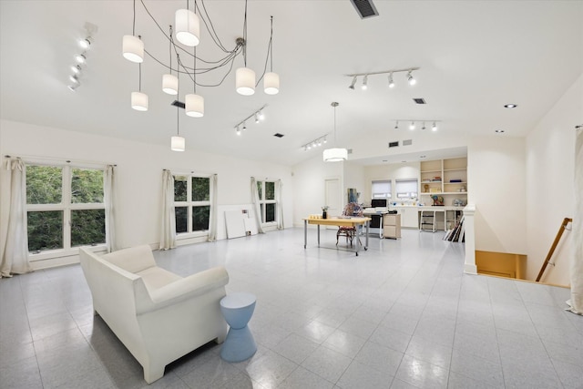 living room with a notable chandelier and vaulted ceiling