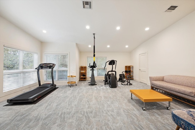 workout room with light colored carpet and lofted ceiling