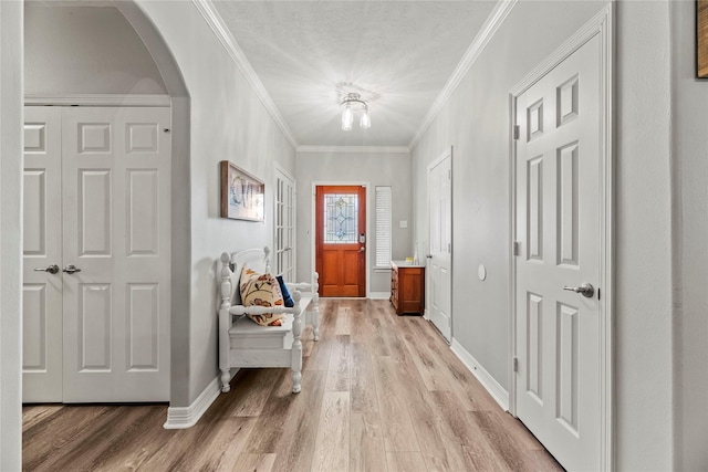 entryway with crown molding and light wood-type flooring