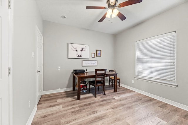 dining space with ceiling fan and light wood-type flooring