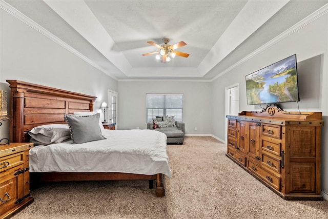 carpeted bedroom featuring a raised ceiling and ceiling fan