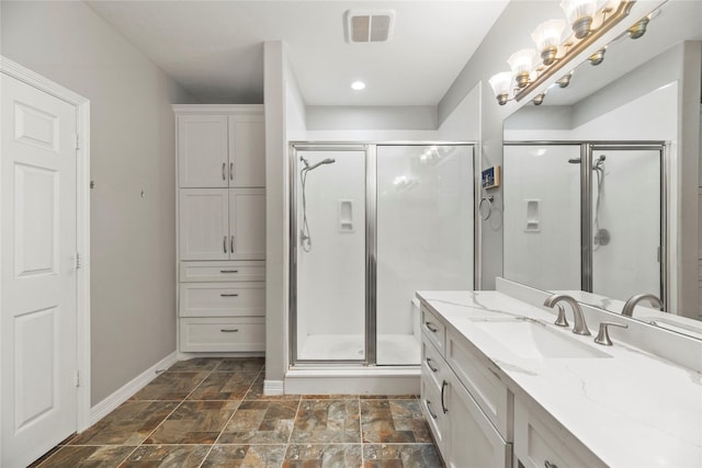 bathroom featuring vanity and an enclosed shower