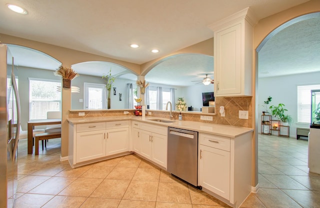 kitchen with ceiling fan, sink, white cabinetry, and stainless steel appliances