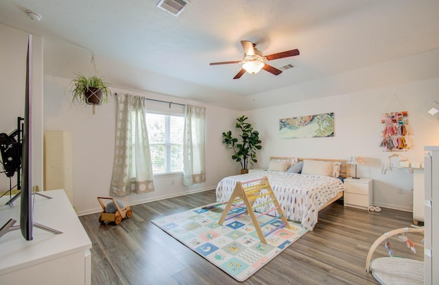 bedroom with ceiling fan and dark wood-type flooring