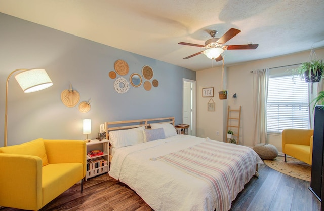 bedroom featuring ceiling fan and dark hardwood / wood-style floors