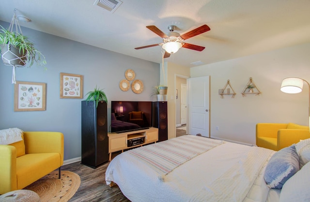 bedroom with dark hardwood / wood-style floors and ceiling fan