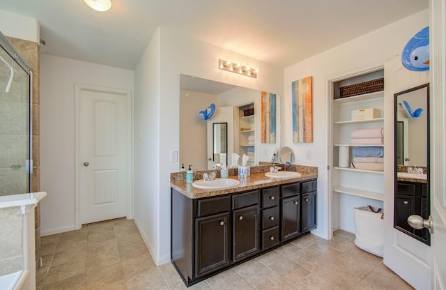 bathroom featuring vanity and a shower with door