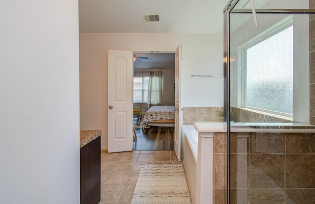 bathroom with ceiling fan, tile patterned flooring, and vanity