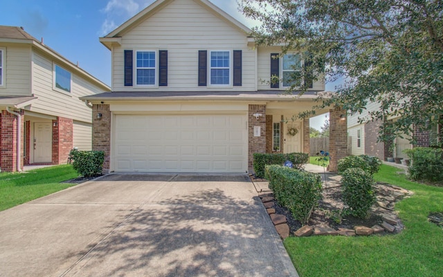 front of property featuring a front yard and a garage