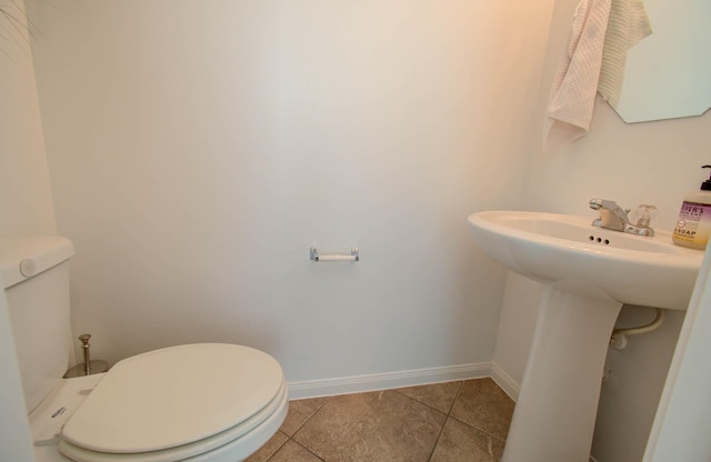 bathroom with tile patterned flooring, toilet, and sink