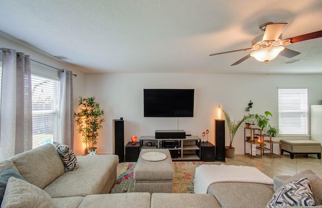 living room with ceiling fan and light tile patterned flooring