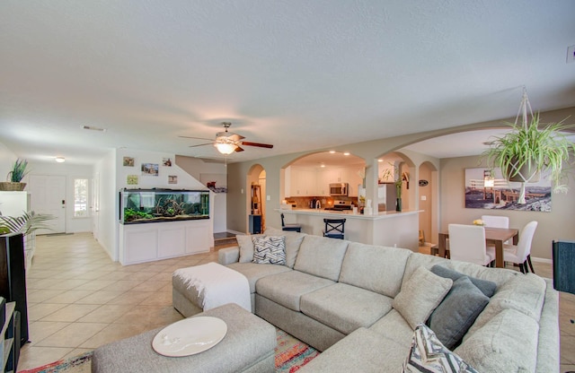 living room featuring ceiling fan and light tile patterned floors