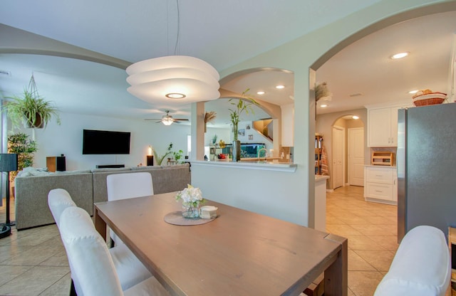 dining area with light tile patterned floors and ceiling fan