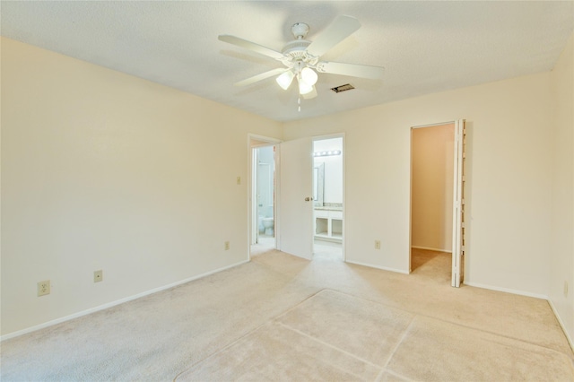 spare room featuring ceiling fan and light colored carpet