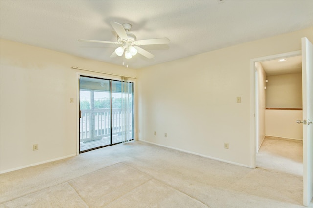 unfurnished room featuring ceiling fan and light carpet