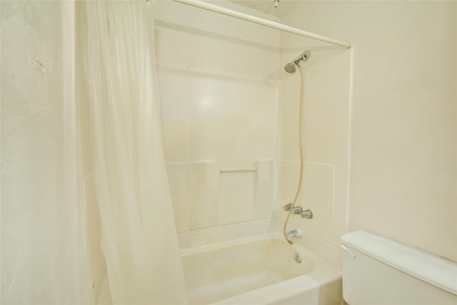 bathroom featuring toilet and shower / bathtub combination with curtain