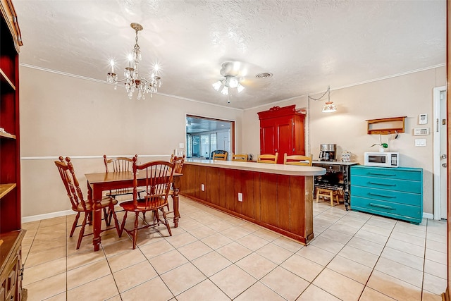 kitchen featuring crown molding, visible vents, white microwave, a textured ceiling, and a peninsula