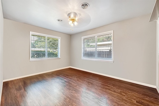 empty room with dark wood-type flooring and ceiling fan