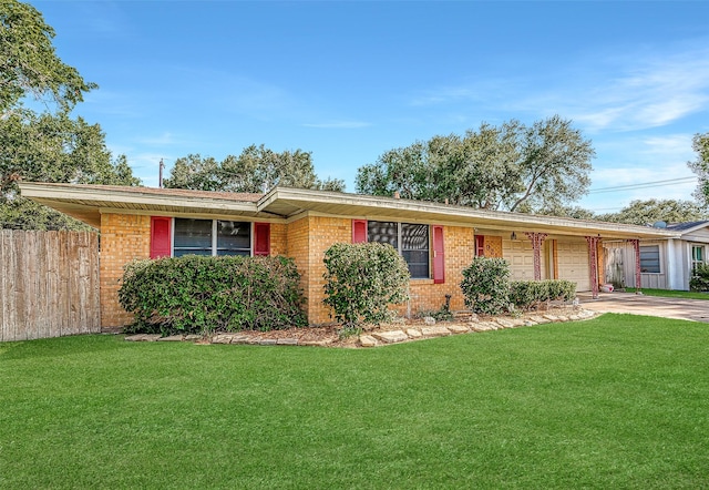 single story home featuring driveway, an attached garage, fence, a front lawn, and brick siding