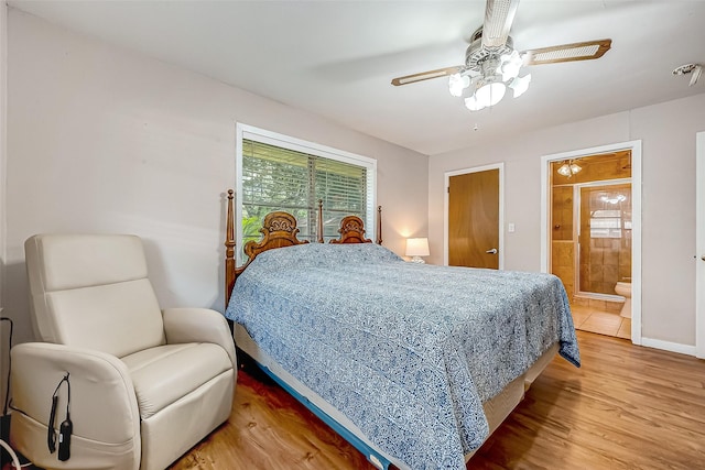 bedroom with baseboards, ensuite bath, a ceiling fan, and light wood-style floors