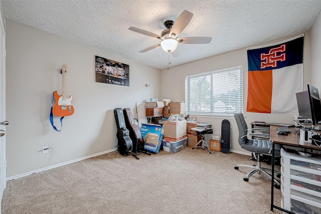 office space featuring a textured ceiling, carpet floors, and ceiling fan